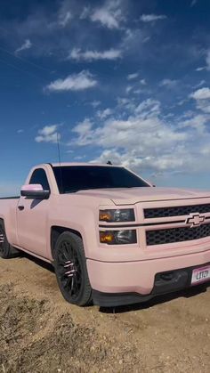 a pink truck is parked on the beach