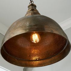 an old fashioned light hanging from the ceiling