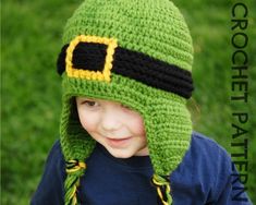 a young child wearing a crocheted green hat