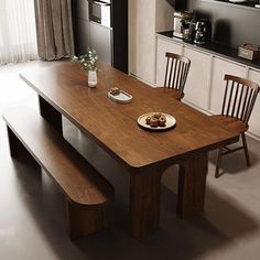 a wooden table with two chairs next to it in a room filled with white walls