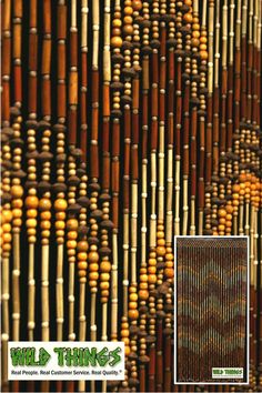 an image of a wall made out of bamboo sticks and wood beads with the words wild things written on it