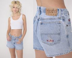 "Vintage 00s denim shorts by Mudd in blue denim with a mid rise waist. Please see measurements and condition below. Every garment we sell is authentic vintage! You will receive the exact item photographed. Condition: Very good vintage with light general wear. Best fits women's: Labelled size 3 Tag: Mudd Material:  Cotton MEASUREMENTS Taken from seam to seam while the garment is lying flat. Double the armpit, waist, and hips For reference, model is 5'7\" and measures 31-24-35. Waist: 14.5\" Hips: Y2k High-rise Medium Wash Shorts, Y2k Medium Wash Mid-rise Jean Shorts, Y2k Mid-rise Medium Wash Jean Shorts, Fitted Denim Shorts In 90s Style, 90s Style Fitted High-waisted Jean Shorts, 90s Style Fitted Jean Shorts, Fitted 90s Style Jean Shorts, 90s Style High-waisted Jean Shorts, Y2k Jean Shorts