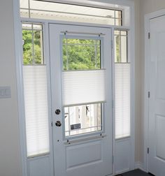 a white door with two windows and blinds