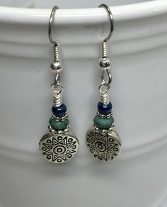 A great pair of earrings fit for any occasion. The Tibetan silver carved bead features and antique sun design with a very modern look. Prepare yourself for compliments. Earrings are made using surgical steel ear wires. I use wrapped loops to give a finished look. Earrings come with rubber ear backs that slide on to keep earrings from falling out of ears. Earring length is under 2 inches. Like them but want a different color? Just request a custom order. I love creating custom work for my custome Vintage Silver Beaded Earrings Nickel Free, Vintage Silver Beaded Nickel-free Earrings, Vintage Silver Nickel-free Beaded Earrings, Diy Earrings Dangle, Wire Jewelry Earrings, Beaded Jewelry Earrings, Diy Jewelry Earrings, Sun Earrings, Beaded Earrings Diy