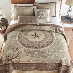 a bed covered in a brown and white comforter