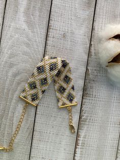 two pieces of beaded hair clips on a wooden surface