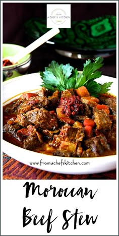 beef stew with carrots and parsley in a white bowl on top of a table