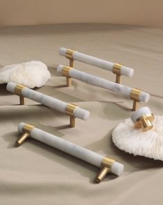 several white and gold objects laying on a bed