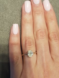 a close up of a person's hand with a ring on their finger and a diamond in the middle