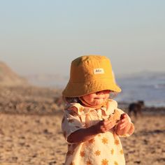 This yellow bucket hat is the perfect thing for babies toddlers and kids on sunny summer days! Washable linen and cotton fabirc makes it an easy go to for at the park, the beach, or even the backyard! This hat will protect delicate skin from the sun and will quickly become a favorite accessory! I made this sun hat from a bold yellow colored linen/cotton blend fabric. The strap closes with snaps under the chin keeps them from pulling it off. Brim measures approx. 2.25 inches. SIZES AVAILABLE 0-3 mos. - fits 14" to 16" head circumference 3-6 mos. - fits 15" to 17" head circumference 6-12 mos. - fits 16" to 18" head circumference 12-24 mos. - fits 17.5" to 19.5" head circumference Small (3 to 5 yrs) - fits 19" to 21" head circumference OVERVIEW + Sewn by me + Yellow Linen and Cotton blend Fab Summer Sun Hat With Uv Protection For Playtime, Uv Protection Sun Hat For Summer Playtime, Summer Playtime Sun Hat With Curved Brim, Adjustable Summer Bucket Hat For Playtime, Playful Cotton Sun Hat For Spring, Summer Bucket Hat For Playtime, Cute Cotton Sun Hat For Vacation, Summer Play Brimmed Bucket Hat, Summer Cotton Bucket Hat With Uv Protection