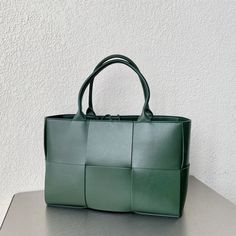 SHOP MORE LUXURY PRODUCTS HERE Description Bottega Veneta Arco Tote Bag For Women 16.14in/41cm In Green 609175VMAY33038 Size: 25 x 41 x 14 cm / 9.84 x 16.14 x 5.5 inches Handle bagDouble handleSingle detachable interior zipped pocket Include dust bag.This product is of the premium quality. Luxury Green Tote Baguette Bag, Green Baguette Tote Bag With Detachable Handle, Green Tote Box Bag With Detachable Strap, Green Square Bag With Detachable Handle, Green Tote Box Bag With Gold-tone Hardware, Bottega Veneta Arco, Chanel Shirt, Louis Vuitton Shirt, Gucci Gg Marmont