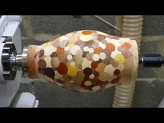 an image of a machine that is making something out of wood and fabric with circles on it