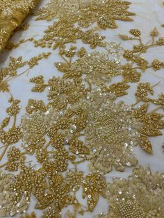 This high quality Fabric is measured in 5 Yards With Embroidered Beading and Sequin. It is soft, very delicate and beautiful. This high Quality Fabric is made with Fashion embroidered rhinestones can be used in making party wedding dresses, skirts, shawls, scarves and other other fashion apparels as you would like. Size : Length : 5 yards (180 inch). Width: 50 inch (Please allow slight deviation for the measurement data ,±1 inch) Material: 100% Polyester, Tulle Lace Fabric, Eco-Friendly embroide Luxury Sequin Fabric For Party Season, Luxury Gold Sequin Fabric With Intricate Embroidery, Luxury Gold Beaded Embroidered Fabric, Elegant Embroidered Fabric With Rhinestones For Wedding, Elegant Rhinestone Embroidered Fabric For Weddings, Gold Embellished Embroidered Fabric For Wedding, Wedding Lace Embroidered Fabric With Rhinestones, Wedding Embroidered Lace Fabric With Rhinestones, Wedding Lace Fabric With Rhinestones