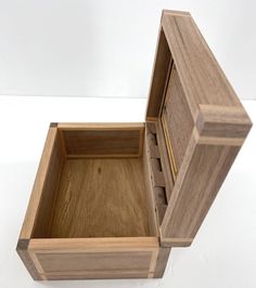 an open wooden box sitting on top of a white table