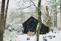 a cabin in the woods is covered with snow