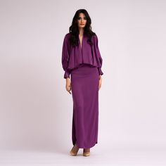 Deep purple dress with deep 'V' neckline and long flared sleeves. Dry clean only. Composition: 60% POLYESTER 40% VISCOSE Party Maxi Dress With Blouson Sleeves, Evening Long Sleeve Maxi Dress With Draped Sleeves, Formal Maxi Dress With Blouson Sleeves, Gala Long Sleeve Maxi Dress With Draped Sleeves, Elegant Bell Sleeve Maxi Dress For Formal Occasions, Formal Long Sleeve Maxi Dress With Draped Sleeves, Elegant Formal Maxi Dress With Bell Sleeves, V-neck Maxi Dress With Draped Sleeves For Gala, Cocktail Maxi Dress With Pleated Long Sleeves