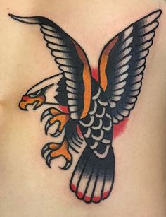 an eagle tattoo on the back of a man's chest, with flames coming out of its wings