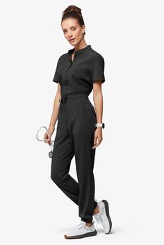 Now, this is modern. A jumpsuit! No easier way to get dressed – nothing to match and your top stays tucked in. Ours is so cute – a drawstring to add shape plus six functional pockets. The Easy Stretch Collection is designed for a modern look and easy fit. 4-way stretch performance fabric keeps you comfortable all shift long. • Modern fit • Open placket neckline • Concealed full-length front zipper • Drawstring waist • Total of 6 pockets • 2 roomy front patch pockets • 1 cellphone pocket • 2 back Scrub Style, Dickies Scrubs, Jumpsuit Outfits, Greys Anatomy Scrubs, Short Sleeve Jumpsuit, Mens Scrubs, Scrub Jackets, Easy Stretches, Tall Pants