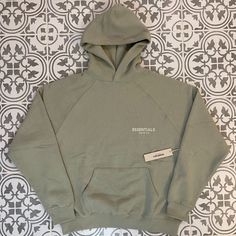 Fear Of God Essentials Sea Foam Hoodie Brand New With Tag Only Size Is Medium Which Fits Oversized Color Is Sea Foam Mails Out Within 24 Hours Green Hooded Sweats For Spring, Spring Khaki Hoodie Sweatshirt, Oversized Khaki Hooded Hoodie, Khaki Cotton Hoodie With Drawstring Hood, Sporty Khaki Hoodie With Drawstring Hood, Khaki Hoodie Sweatshirt For Streetwear, Sporty Khaki Sweatshirt With Drawstring Hood, Oversized Khaki Hoodie With Ribbed Cuffs, Sporty Khaki Hoodie With Pockets