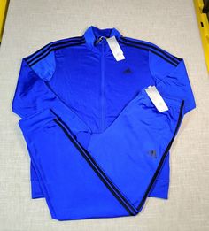 Blue Activewear For Jogging With Three Stripes, Blue Long Sleeve Tracksuit For Sports, Adidas Blue Track Jacket With Three Stripes, Adidas Blue Activewear With Three Stripes, Adidas Blue Outerwear With Three Stripes Branding, Adidas Blue Outerwear With Three Stripes, Blue Adidas Activewear For Jogging, Stretch Blue Tracksuit For Winter, Blue Stretch Tracksuit For Winter