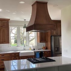 a kitchen with an oven, stove and sink in it's center island area