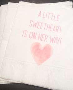 three napkins with the words a little sweetheart is on her way