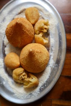 three pieces of bread on a plate with powdered sugar