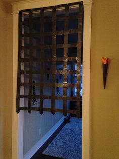 an open door with a decorative screen on the front and back wall in a hallway