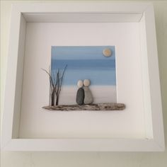 two rocks sitting on top of a wooden shelf