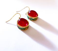 Golden plated Earrings Red Carnelian Gem. Coloured Cloisonne enameled. High quality.    Handmade ethnic antique design egyptian style ring Metal Type - 18k Gold plated Gem Colour - Red The earrings are delivered with a jewelry box.  Combined shipping! Festive Red Brass Earrings, Traditional Red Enamel Jewelry, Red Enamel Traditional Earrings, Traditional Red Enamel Earrings, Traditional Red Brass Earrings, Red Hand Painted Round Earrings, Brass Meenakari Earrings Gift, Hand Painted Red Elegant Earrings, Meenakari Brass Earrings Gift