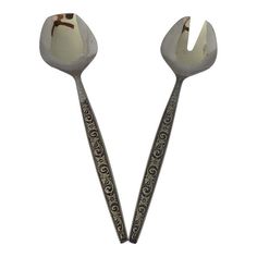 two spoons with ornate designs on them, one has a fork in the middle