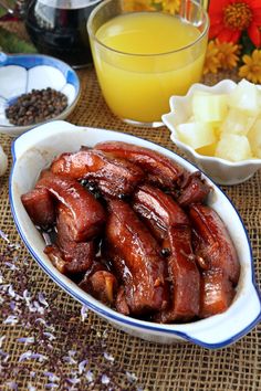 there are many different foods in the bowl and on the table, including meats