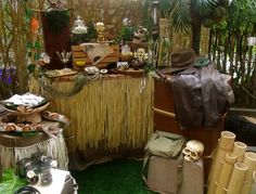 an assortment of items on display in a room with plants and other things around it