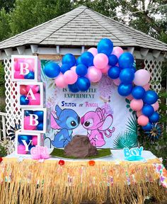 a stitch & angel themed banner is hung behind a table with a DIY volcano placed on top of it. there is a pink & blue balloon arch above the banner & on the sides of the volcano it says “boy, girl”. the table has a table skirt on it & there are boxes on the left side that say “baby”. Lilo Gender Reveal, Stitch Themed Gender Reveal Ideas, Gender Reveal Ideas Anime, Gender Reveal Ideas Hawaiian, Gender Reveal Ideas Cartoon Theme, Cartoon Theme Gender Reveal, Gender Reveal Ideas Cartoon