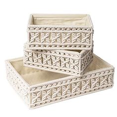 two white baskets sitting on top of each other