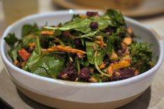 a white bowl filled with salad on top of a table