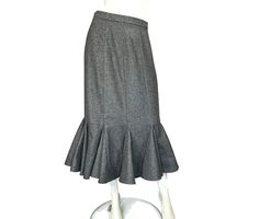 Eighties does thirties with this gray midi length wool blend deep gored hem skirt. Skirt is unlined. In excellent condition. Label: Stirling Cooper, London, Size 3, 45% Wool, 45% Polyester, 10% Other Fibres, Dry Clean Only Measurements  Waist: 28 inches, 71cm Hip: 40 inches, 101.5cm Waist to Hem: 32 inches, 81cm Zipper: at back 7 inches, 18cm Button: at top of zipper All measurements taken flat and doubled where appropriate. All my  items are vintage and may have signs of wear. I try to show or Stirling Cooper, Vintage Fitted Accordion Pleated Skirt, Distressed Medium Wash Mid-rise Skirt, Gray Midi Skirt, Vintage Medium Wash Cotton Denim Skirt, Fitted Gray Wool Skirt, Mid-rise Distressed Cotton Skirt, Distressed Mid-rise Blue Skirt, Fashion Library