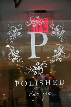 a glass window with the words poshed day spa written in white on it