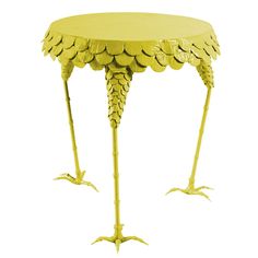 an artistically designed table with two legs and large leaves on the top, made out of cardboard