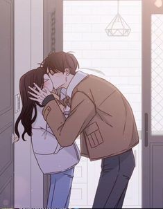 a man and woman kissing in front of an open door with their hands on each other's face