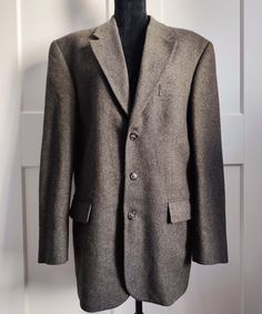 Minimalist men's blazer made of wool. It's perfect for spring and autumn layering style. It has two pockets and buttons on the front side and on the sleeves. It is fully lined. The jacket fits best men's sizes L or XL. Looks great styled oversized.  Check the exact measurements below: Shoulders: 52cm / 20.5 in Sleeves (from armpit): 42 cm / 16.5 in Length: 80 cm / 31.5 in All items are measured flat. The colors of the actual items can vary slightly from the colors in the photos. The blazer is in excellent vintage condition. **Vintage items may have minor flaws due to pre-loved wear and or age. In general, we do not sell clothes with major flaws.** Long Sleeve Sport Coat With Welt Pockets For Business, Fall Business Sport Coat With Welt Pockets, Business Sport Coat With Pockets And Long Sleeves, Single Button Long Sleeve Tweed Jacket For Business, Classic Single Button Wool Coat For Business, Wool Long Sleeve Business Sport Coat, Classic Tweed Jacket With Pockets For Business, Wool Long Sleeve Sport Coat For Business, Business Long-sleeve Tweed Jacket With Pockets