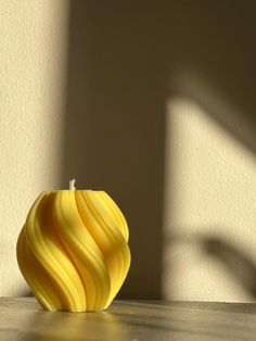 a yellow apple sitting on top of a wooden table