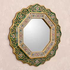 a decorative mirror mounted to the side of a wall