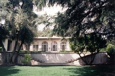 a house with trees and grass in front of it