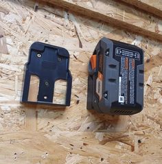 two different types of power tools sitting on top of plywood