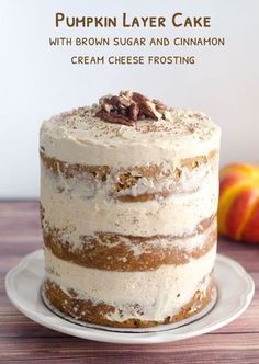 a cake sitting on top of a white plate next to an orange and red apple