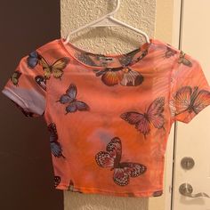 Fashion Nova Crop Top. Mesh See Thru. Size Xs (True To Size) No Tags But Never Worn And In 100% Perfect Condition. Open To Offers Printed Short Sleeve Crop Top, Fitted Summer Top With Butterfly Print, Fitted Butterfly Print Top For Summer, Orange Short Sleeve Crop Top For Summer, Multicolor Graphic Print Crop Top, Trendy Orange Short Sleeve Crop Top, Multicolor Butterfly Print Top For Summer, Multicolor Butterfly Print Tops For Summer, Fitted Short Sleeve Top With Butterfly Print