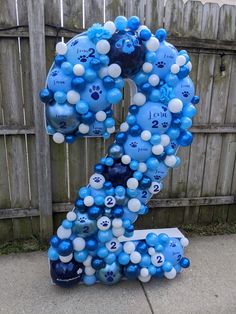 a number made out of balloons in the shape of a dog's paw is shown