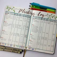 an open planner with writing on it next to markers and pencils in front of them