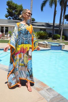 Absolutely stunning designer print, silk caftan, with it's breathtaking art print, would be a very special addition to your wardrobe. This luxurious, silk caftan is the height of glamour for beach, pool, that special vacation or just looking fantastic lounging or entertaining. One size. Fits many sizes, small to X-large. The width, edge to edge, is 54 inches or 108 inches around the body. The length is 52 inches. The side seams are 7 inches from the edge and can be adjusted if needed. The neckli Silk Kaftan With Vibrant Print For Summer, Bohemian Summer Kaftan With Bold Print, Silk Multicolor Print Kaftan For Vacation, Beach Kaftan With Digital Print, Vacation Kaftan With Digital Print And Kimono Sleeves, Vacation Kaftan With Kimono Sleeves And Digital Print, Beach Dresses With Digital Print And Kimono Sleeves, Beach Kaftan With Digital Print In Tunic Style, Silk Printed Kimono For Vacation